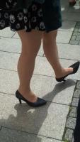 candid street in Prague - beautiful woman in sexy skirt  cross legs
