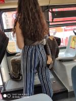 Big round ass in striped pants in bus