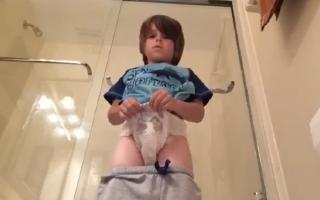 Cute boy showing off his wet diaper