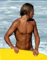 UNAWARES - Surfer boy on beach