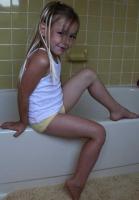 little  girl playing in a tub