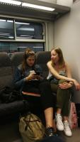 Redhead and brunette friend riding the train